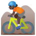 🚵🏿 person mountain biking: dark skin tone display on Google